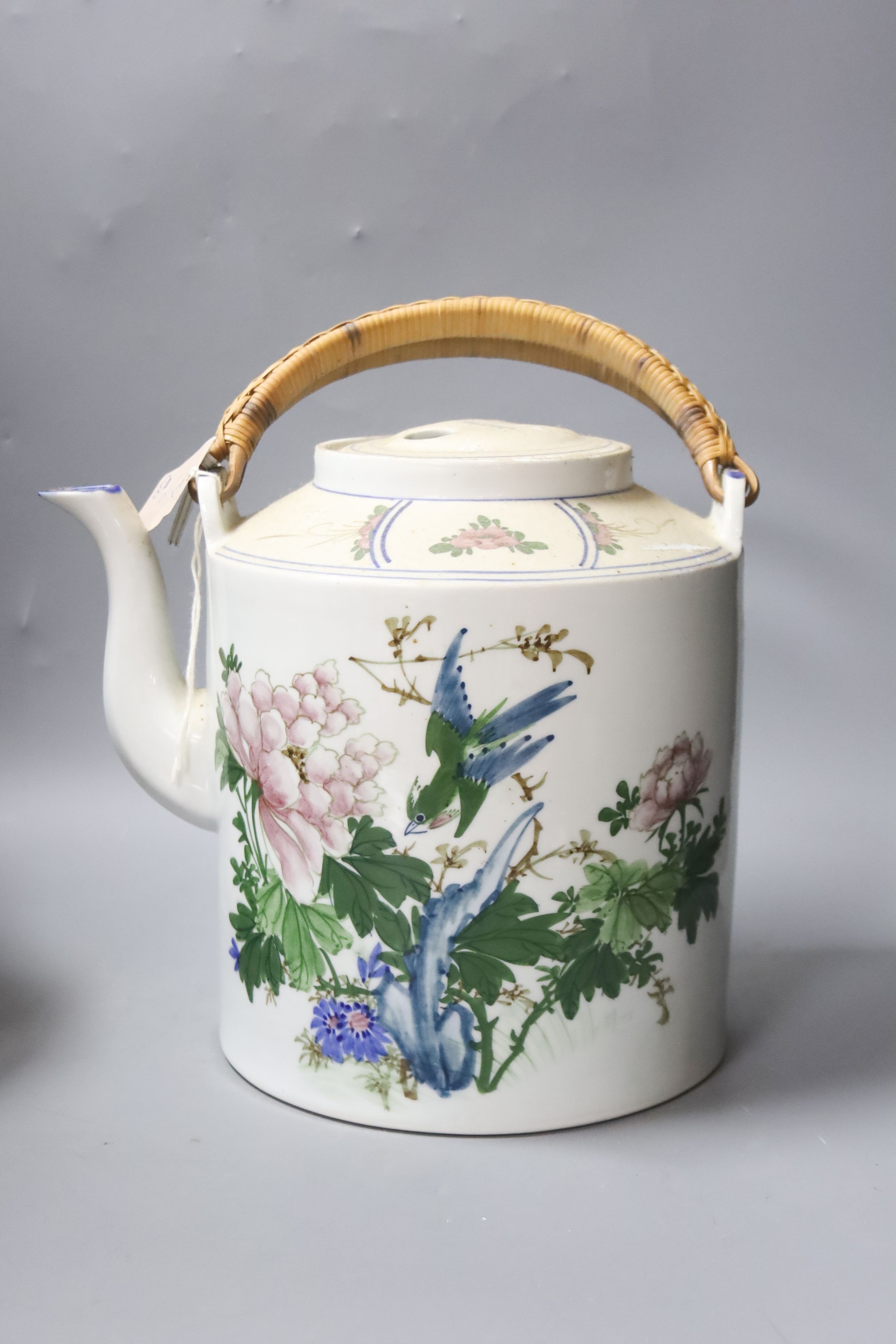 A Chinese large cylindrical porcelain teapot, with bamboo handle and polychrome-decorated with flowers and birds, H 24cm, together with two Japanese red-lacquered containers